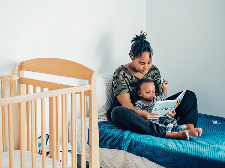 A young mother reads to her child at Rosalie Hall